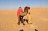 Bedouin and his camel in the desert of Rub Al Khali